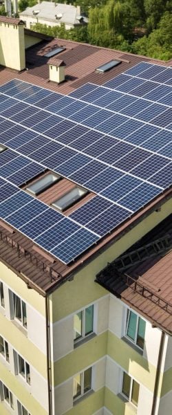aerial-view-many-solar-panels-building-roof-min