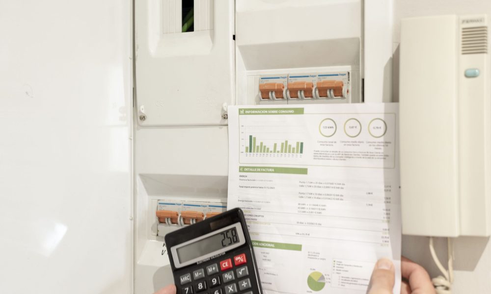 hand-holding-electricity-bill-calculator-front-power-control-switch-min (1)