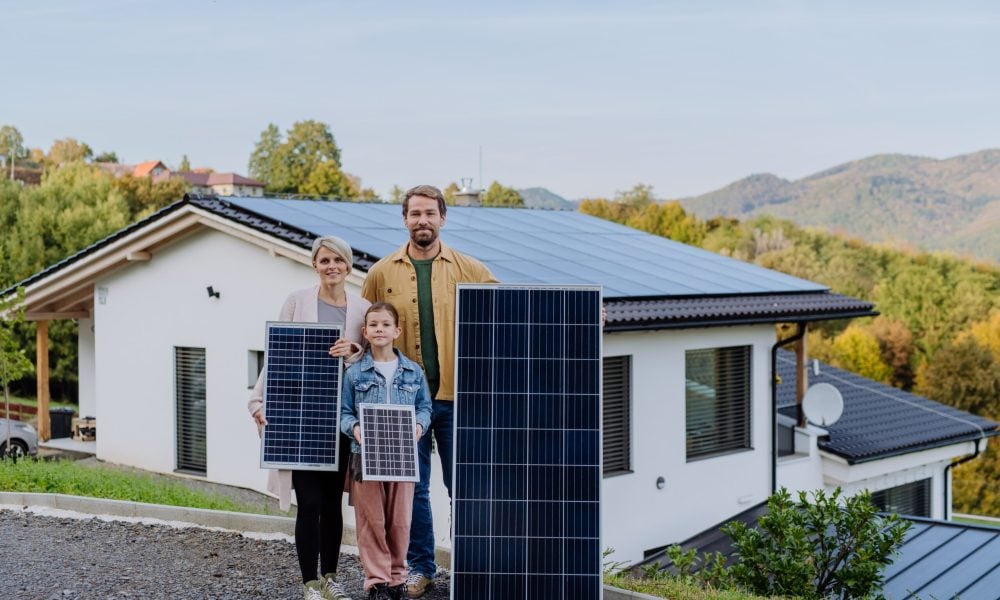 happy-family-near-their-house-with-solar-panels-alternative-energy-saving-resources-sustainable-lifestyle-concept-min