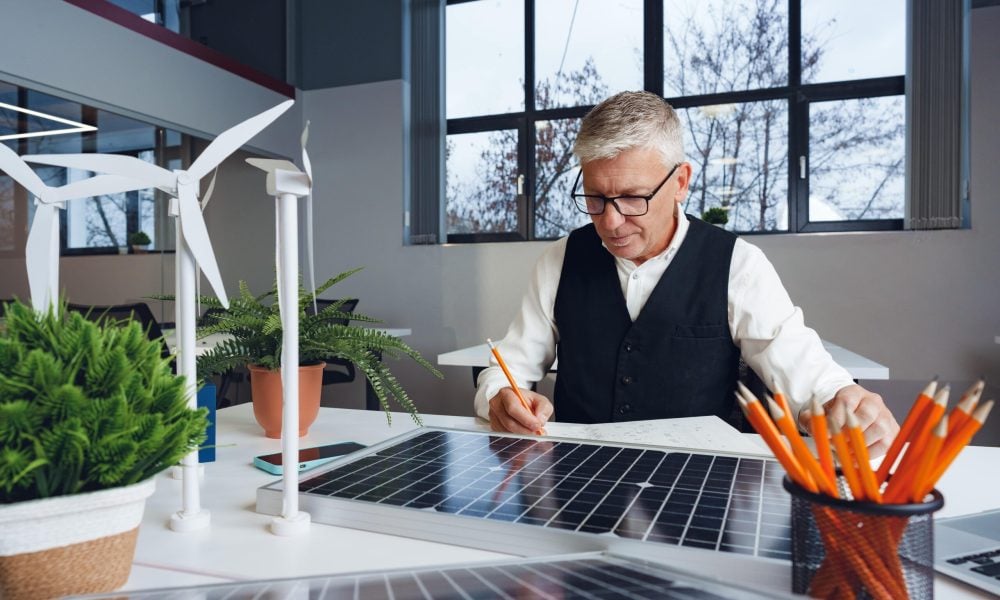 male-mature-architect-working-ecological-construction-project-office-min