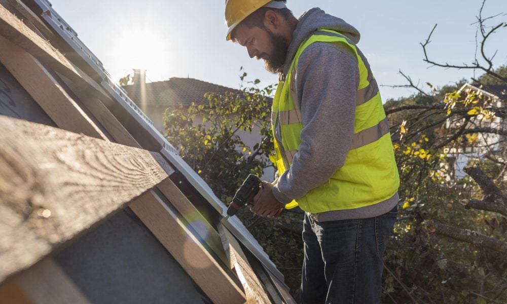 man-working-roof-with-drill-min