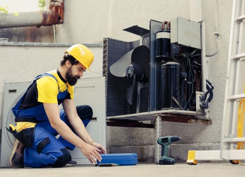 wireman-fixing-broken-air-conditioner-min